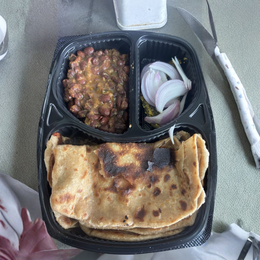 Actual delivered rajma with roti in tiffin container
